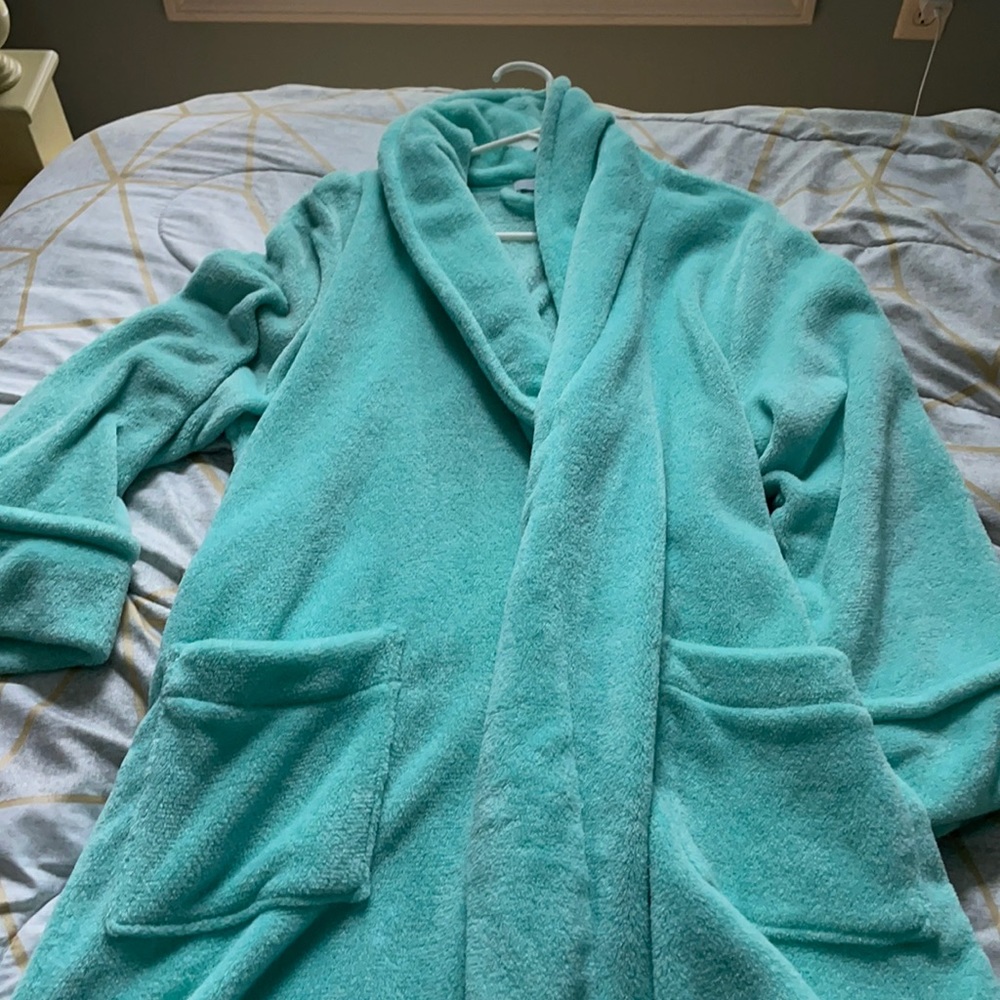 Turquoise bathrobe with a detachable tie.